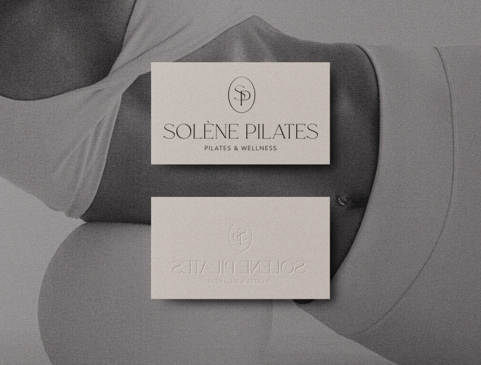 Solène Pilates business cards showing the wordmark, SP monogram and blind-embossed reverse